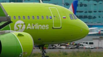 NOVOSIBIRSK, RUSSIAN FEDERATION JULY 15, 2022 Passenger Airbus A320neo of S7 Airlines taxiing at Tolmachevo airport, close up side view. Airplane on the taxiway. Passenger flight, airfield video