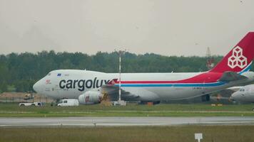 NOVOSIBIRSK, RUSSIAN FEDERATION JUNE 10, 2020 Airbus A321 211, VQ BTU of Aeroflot plane taxiing to the terminal at Tolmachevo airport, Novosibirsk. Boeing 747 Cargolux background video