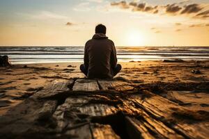 Distressed individual sitting alone displaying sadness on an eerily quiet beach photo