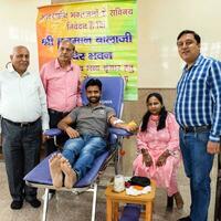 Delhi, India, June 19 2023 - Blood donor at Blood donation camp held at Balaji Temple, Vivek Vihar, Delhi, India, Image for World blood donor day on June 14 every year, Blood Donation Camp at Temple photo