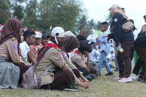 Gorontalo, Indonesia - August 17, 2023 - Scout members assisted in the organization of the flag lowering ceremony during the 78th Independence Day of Indonesia. Anggota pramuka photo