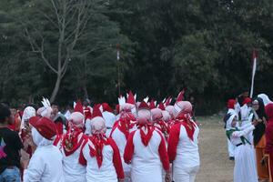 Gorontalo, Indonesia - August 17, 2023 - The Indonesian flag lowering ceremony witnessed by villagers. Indonesia Independence Day photo