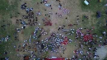 Aerial view of Indonesian flag lowering ceremony witnessed by villagers. Indonesia Independence Day photo