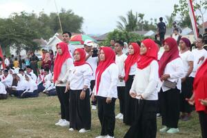 Gorontalo, Indonesia - August 17, 2023 - A group of hearing-impaired individuals becomes a choir guide group during the commemoration of Indonesia's 78th Independence Day photo