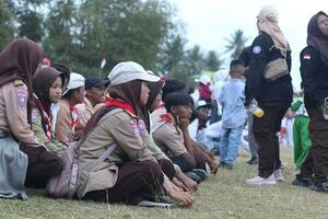 Gorontalo, Indonesia - August 17, 2023 - Scout members assisted in the organization of the flag lowering ceremony during the 78th Independence Day of Indonesia. Anggota pramuka photo