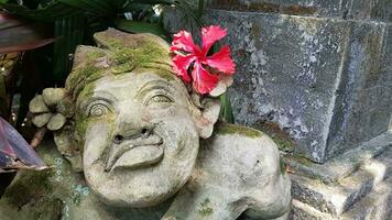 Beautiful artistic Bali stone statue of a Balinese ancient garden statue used as garden decoration, javanese gnome indonesia photo