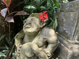 Beautiful artistic Bali stone statue of a Balinese ancient garden statue used as garden decoration, javanese gnome indonesia photo