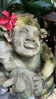 Beautiful artistic Bali stone statue of a Balinese ancient garden statue used as garden decoration, javanese gnome indonesia photo