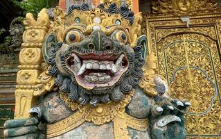 Traditional old ancient Balinese statue of demon angel called barong bali guarding sacred ritual temple photo