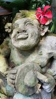 Beautiful artistic Bali stone statue of a Balinese ancient garden statue used as garden decoration, javanese gnome indonesia photo