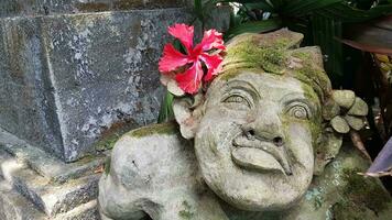 Beautiful artistic Bali stone statue of a Balinese ancient garden statue used as garden decoration, javanese gnome indonesia photo