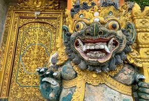 Traditional old ancient Balinese statue of demon angel called barong bali guarding sacred ritual temple photo