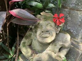 Beautiful artistic Bali stone statue of a Balinese ancient garden statue used as garden decoration, javanese gnome indonesia photo