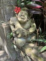 Beautiful artistic Bali stone statue of a Balinese ancient garden statue used as garden decoration, javanese gnome indonesia photo