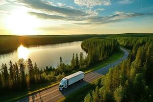 aéreo ver de un camión conducción a lo largo el la carretera a puesta de sol. aéreo ver de semi camión con carga remolque en la carretera curva a lago apuntalar con verde pino bosque. transporte fondo, ai generado foto