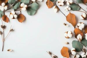 Autumn composition. Frame made of eucalyptus branches, cotton flowers, dried leaves on pastel gray background. Autumn, fall concept. Flat lay, top view, copy space. generative ai. photo