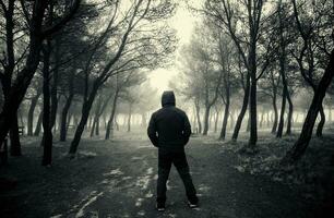 Man in dark forest photo