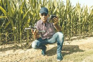 modern technological farmer as he prepares to fly the drone over his cultivated fields photo