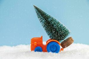 christmas tree on toy car drive over snow photo