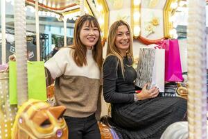 couple of multiethnic young women having fun after shopping photo