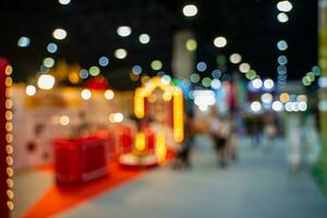 Blurred images of trade fairs in the big hall. image of people walking on a trade fair exhibition or expo where business people show innovation activity and present products in a big hall. photo