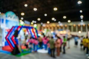 Blurred images of trade fairs in the big hall. image of people walking on a trade fair exhibition or expo where business people show innovation activity and present products in a big hall. photo