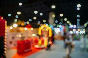 Blurred images of trade fairs in the big hall. image of people walking on a trade fair exhibition or expo where business people show innovation activity and present products in a big hall. photo