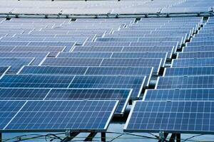 Side view of solar panels floating on water in a lake, for generating electricity from sunlight, selective focus, soft focus. photo