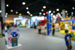 Blurred images of trade fairs in the big hall. image of people walking on a trade fair exhibition or expo where business people show innovation activity and present products in a big hall. photo