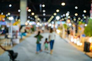 Blurred images of trade fairs in the big hall. image of people walking on a trade fair exhibition or expo where business people show innovation activity and present products in a big hall. photo