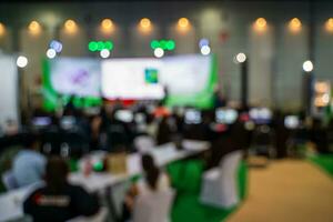 Blurred images of trade fairs in the big hall. image of people walking on a trade fair exhibition or expo where business people show innovation activity and present products in a big hall. photo