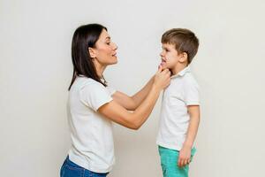 Attractive woman speech therapist teaches child to pronounce sounds and words correctly in office photo