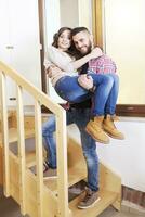 young man holding his girlfriend in his arms after moving photo