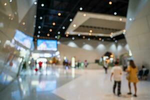 Blurred images of trade fairs in the big hall. image of people walking on a trade fair exhibition or expo where business people show innovation activity and present products in a big hall. photo