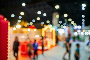 Blurred images of trade fairs in the big hall. image of people walking on a trade fair exhibition or expo where business people show innovation activity and present products in a big hall. photo