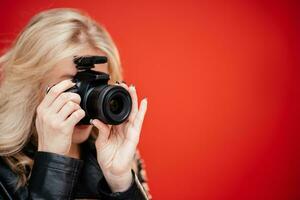 Portrait of a beautiful woman photographer who takes pictures in a photo studio