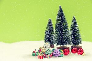 miniature of christmas trees with colored gifts photo