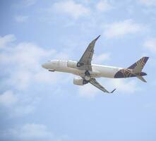 New Delhi, India, July 16 2023 - Vistara Airbus A320 neo take off from Indra Gandhi International Airport Delhi, Vistara domestic aeroplane flying in the blue sky during day time photo