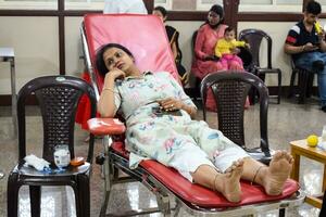 Delhi, India, June 19 2023 - Blood donor at Blood donation camp held at Balaji Temple, Vivek Vihar, Delhi, India, Image for World blood donor day on June 14 every year, Blood Donation Camp at Temple photo