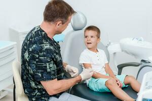 The dentist tells the child how to care for teeth and maintain hygiene photo