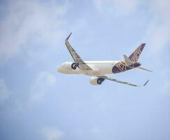 New Delhi, India, July 16 2023 - Vistara Airbus A320 neo take off from Indra Gandhi International Airport Delhi, Vistara domestic aeroplane flying in the blue sky during day time photo