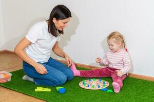 Woman speech therapist teaches a girl the correct pronunciation and literate speech photo