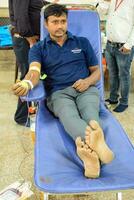 Delhi, India, July 19 2023 - Blood donor at Blood donation camp held at Balaji Temple, Vivek Vihar, Delhi, India, Image for World blood donor day on June 14 every year, Blood Donation Camp at Temple photo