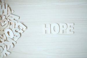 The word HOPE, wooden letters on a wooden table. photo