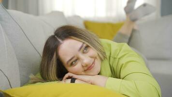 Young woman lying on the sofa is resting. video