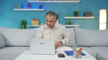 Home office worker man rejoices at what he sees on the laptop. video