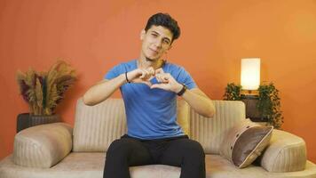 Man making heart sign at camera. video