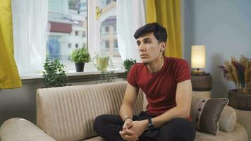 Pensive man is watching outside. video