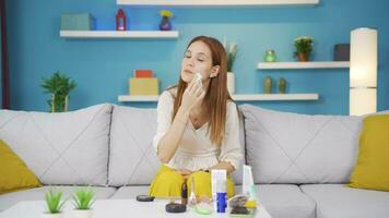 A young woman trying to remove her make-up. video