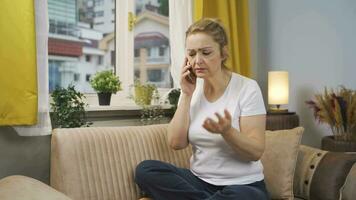 The woman is talking on the phone, arguing. video